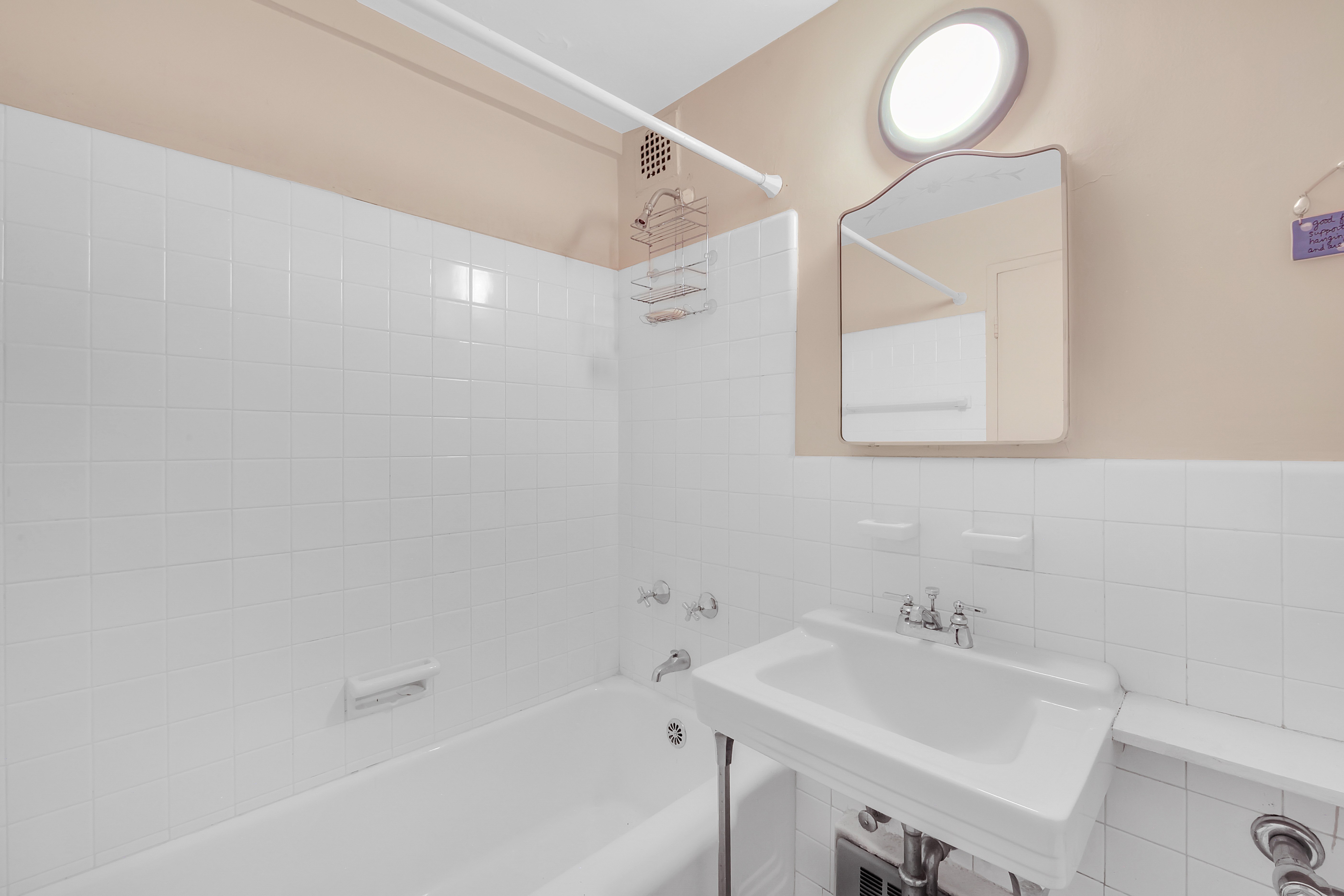 Undisclosed Address Manhattan, NY 10128 - Photo 6 of 9 a bathroom with a sink and a bathtub