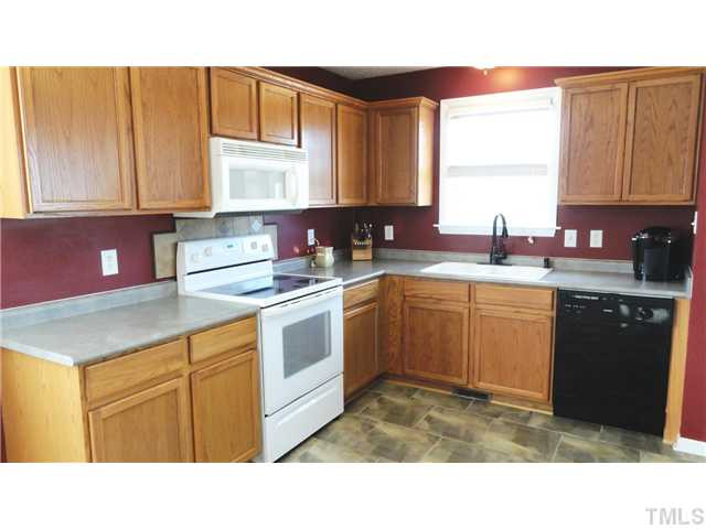 297 Rosa Circle Willow Spring, NC 27592 - Photo 13 of 23 a kitchen with a sink stove and cabinets