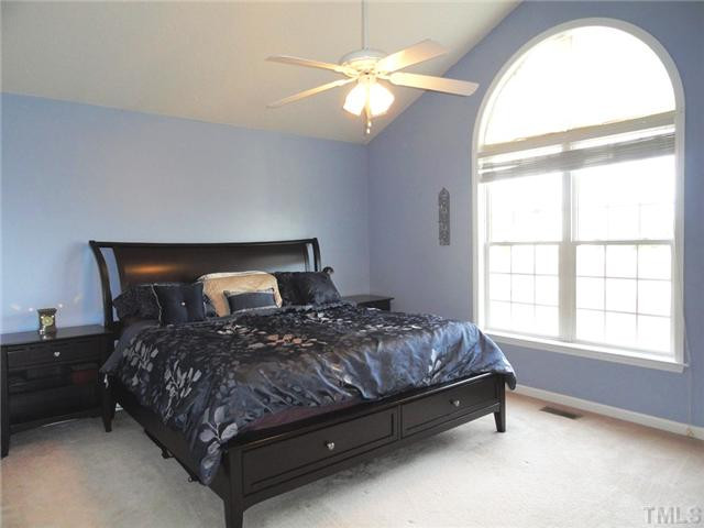 297 Rosa Circle Willow Spring, NC 27592 - Photo 14 of 23 a bedroom with a bed and a large window
