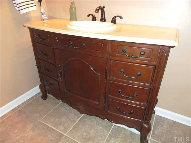 297 Rosa Circle Willow Spring, NC 27592 - Photo 16 of 23 a bathroom with a sink vanity and a mirror