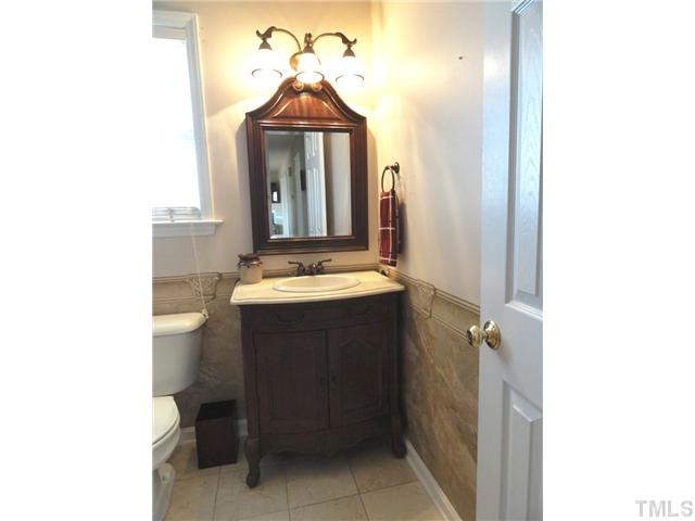 297 Rosa Circle Willow Spring, NC 27592 - Photo 19 of 23 a bathroom with a sink vanity and toilet