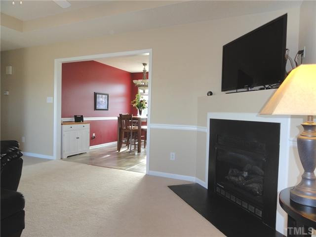 297 Rosa Circle Willow Spring, NC 27592 - Photo 8 of 23 a living room with furniture and a flat screen tv