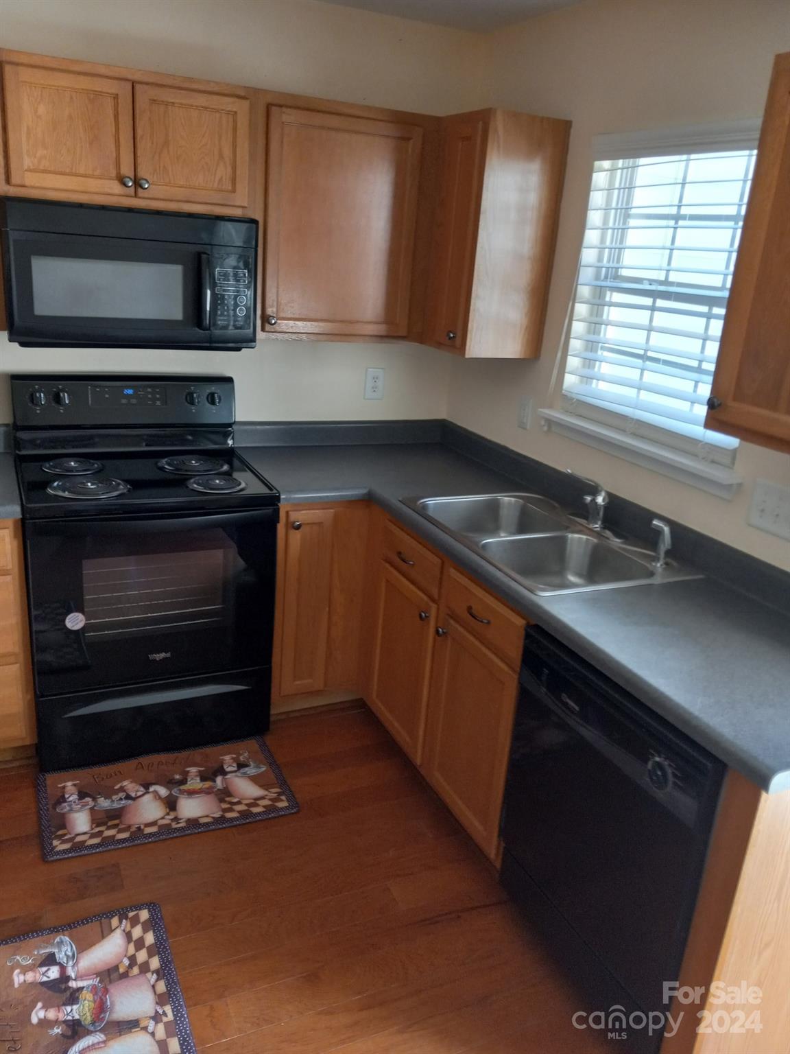 11015 Kinston Ridge Place Charlotte, NC 28273 - Photo 2 of 10 a kitchen with stainless steel appliances granite countertop a stove a sink and a microwave