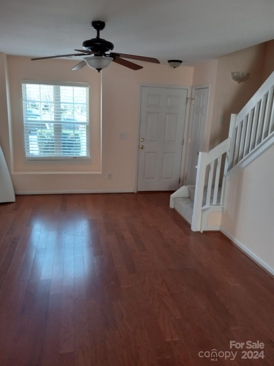 11015 Kinston Ridge Place Charlotte, NC 28273 - Photo 3 of 10 an empty room with wooden floor ceiling fan and windows