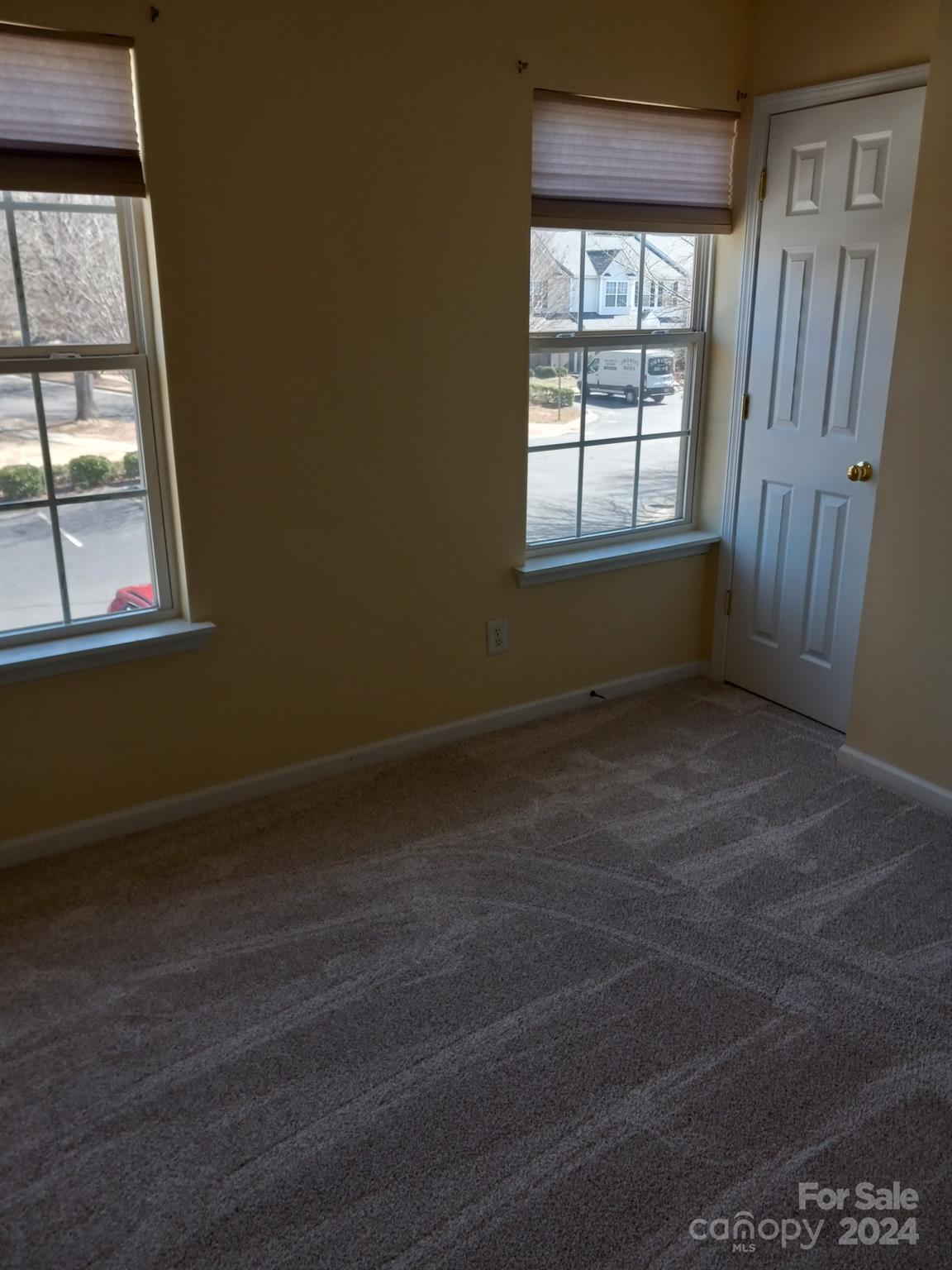 11015 Kinston Ridge Place Charlotte, NC 28273 - Photo 6 of 10 an empty room with wooden floor and windows