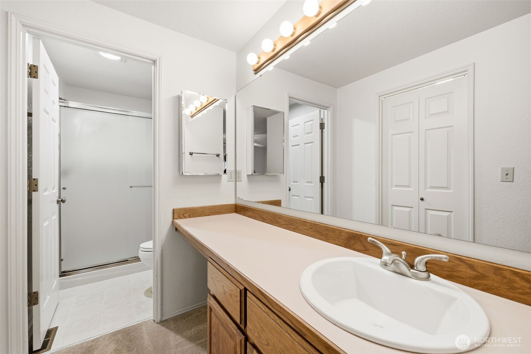 7904 53rd Street West University Place, WA 98467 - Photo 18 of 29 a bathroom with a sink and a mirror