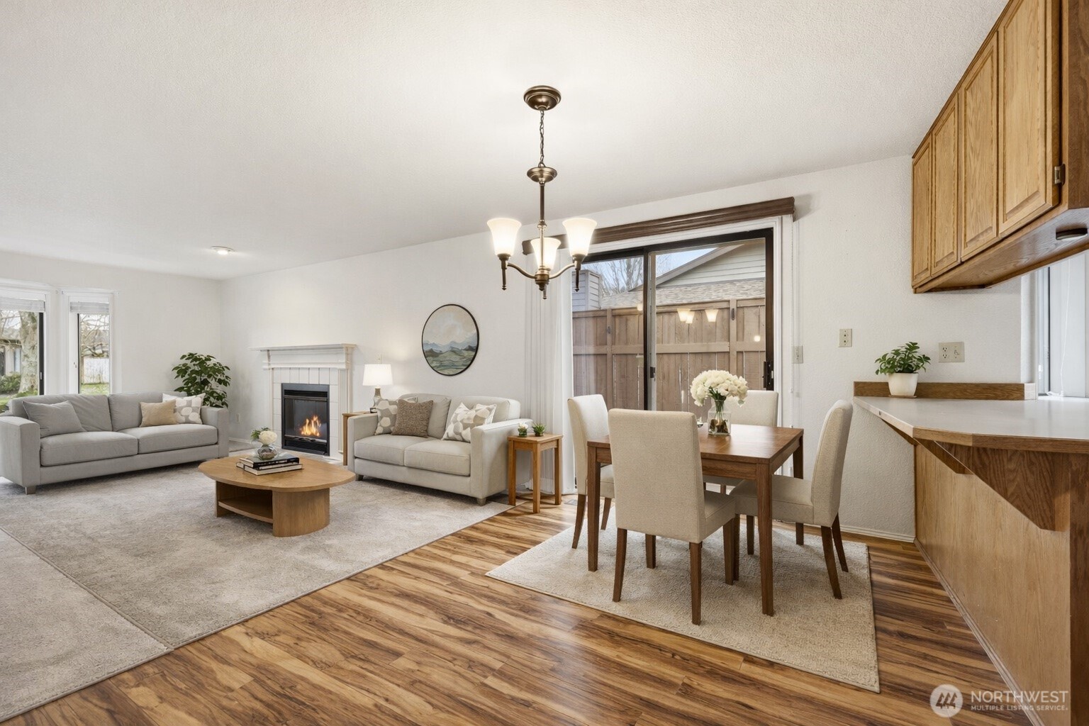 7904 53rd Street West University Place, WA 98467 - Photo 5 of 29 a living room with furniture a rug a fireplace and a chandelier