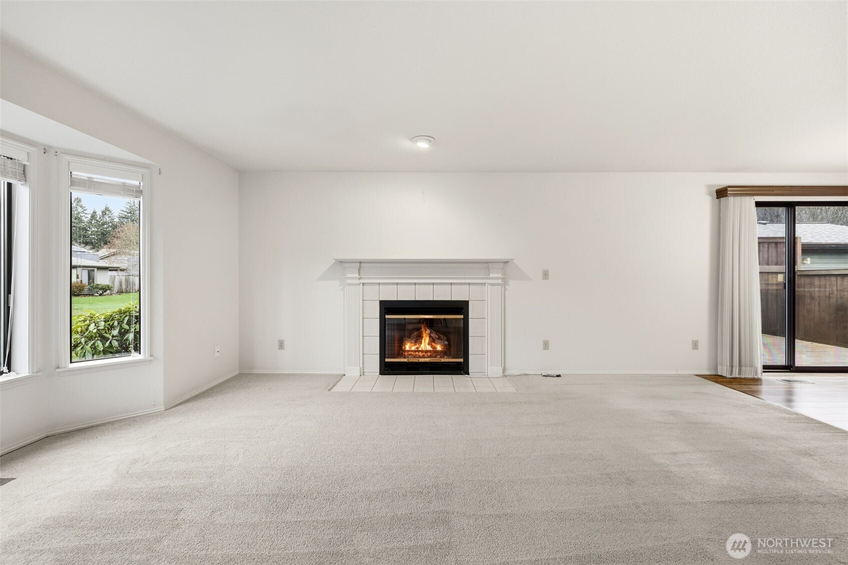 7904 53rd Street West University Place, WA 98467 - Photo 9 of 29 an empty room with windows and fireplace