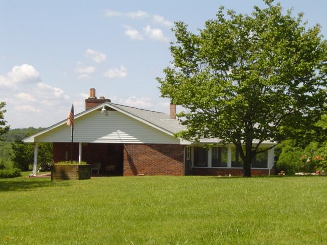 1370 Johnny's Ridge Road Ferrum, VA 24088 - Photo 2 of 24 a front view of a house with a garden and trees