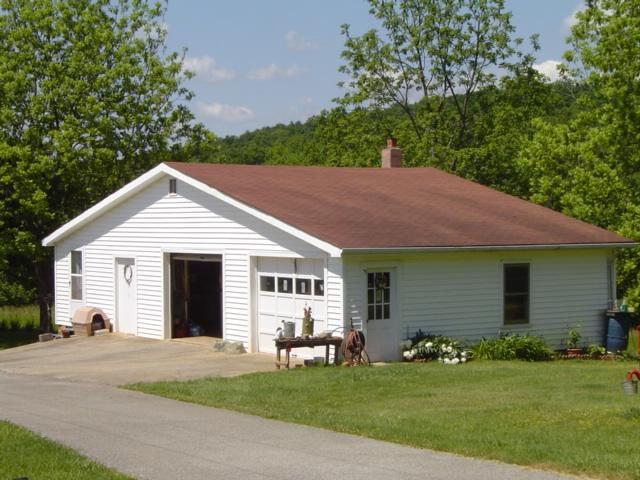 1370 Johnny's Ridge Road Ferrum, VA 24088 - Photo 15 of 24 a view of a white house next to a yard and large trees