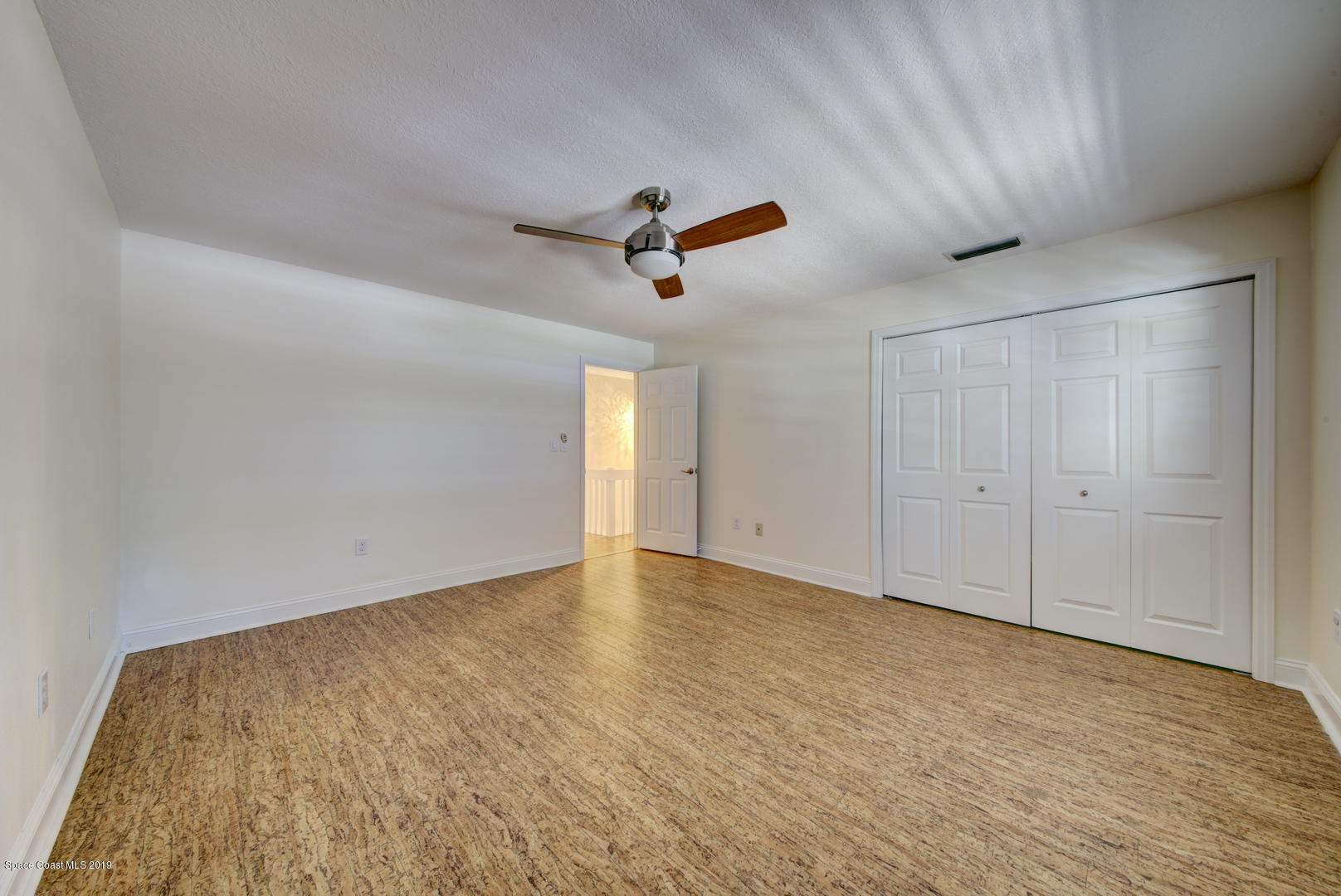 5725 Lake Washington Road Melbourne, FL 32934 - Photo 26 of 72 Bedroom 3 with Cork Floor