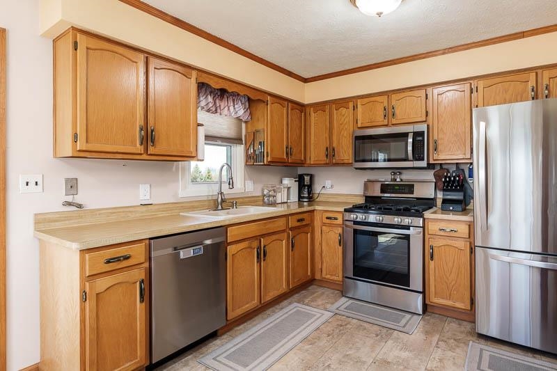 5280 Sunbird Drive Loves Park, IL 61111 - Photo 13 of 42 a kitchen with stainless steel appliances granite countertop a stove a sink dishwasher a refrigerator and a microwave