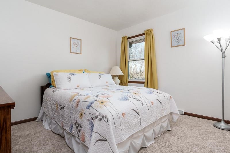 5280 Sunbird Drive Loves Park, IL 61111 - Photo 18 of 42 a bedroom with a bed and window