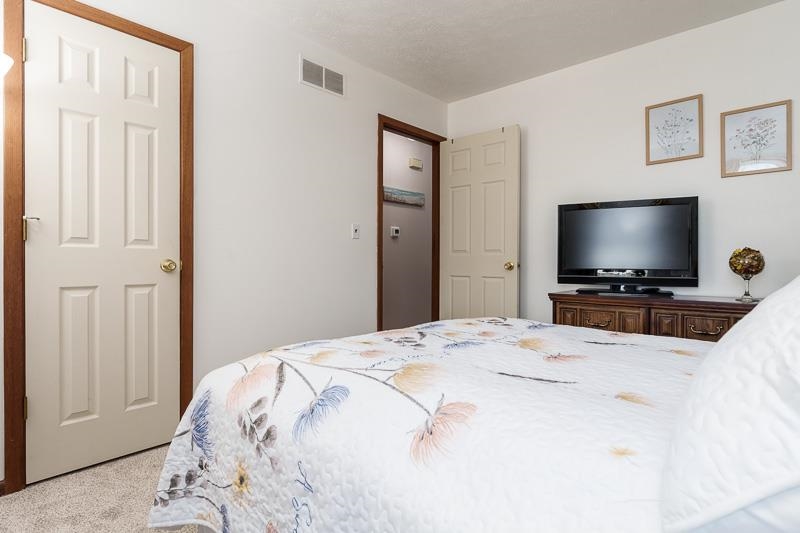 5280 Sunbird Drive Loves Park, IL 61111 - Photo 19 of 42 a bedroom with a flat screen tv and a bed