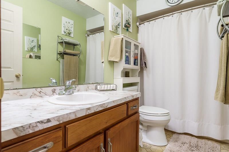 5280 Sunbird Drive Loves Park, IL 61111 - Photo 20 of 42 a bathroom with a granite countertop sink toilet and shower