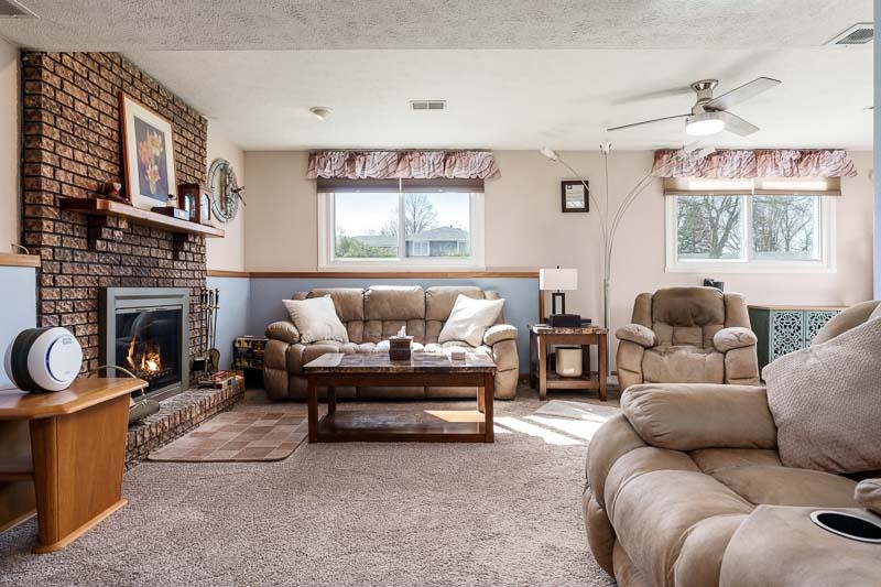 5280 Sunbird Drive Loves Park, IL 61111 - Photo 23 of 42 a living room with furniture and a fireplace