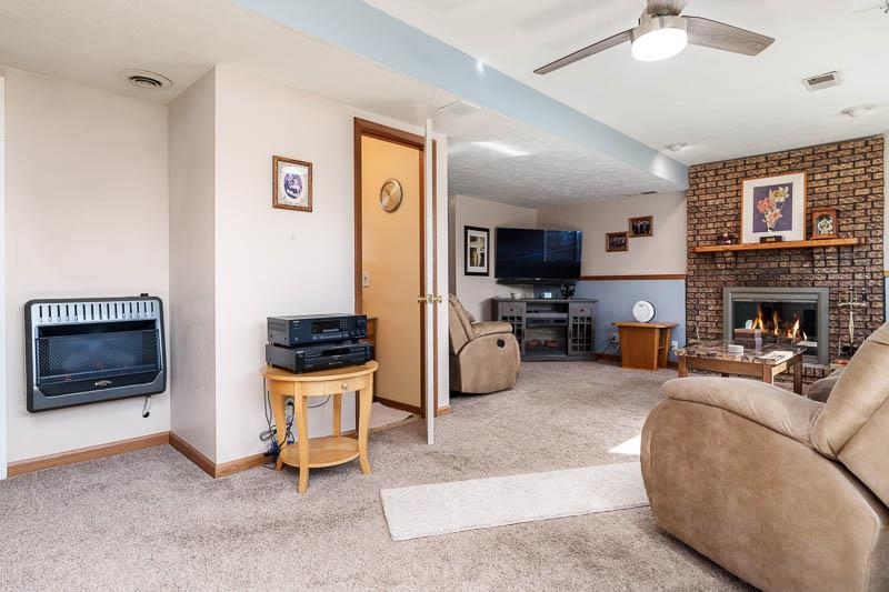 5280 Sunbird Drive Loves Park, IL 61111 - Photo 28 of 42 a living room with furniture and a fireplace