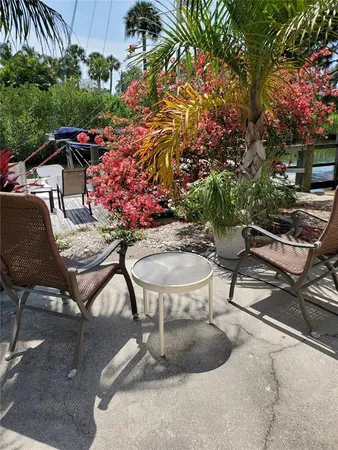 a view of a backyard with sitting area