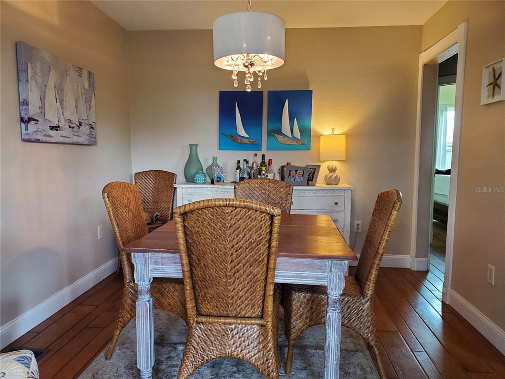 227 Lychee Road Nokomis, FL 34275 - Photo 2 of 36 a dining room with furniture and wooden floor