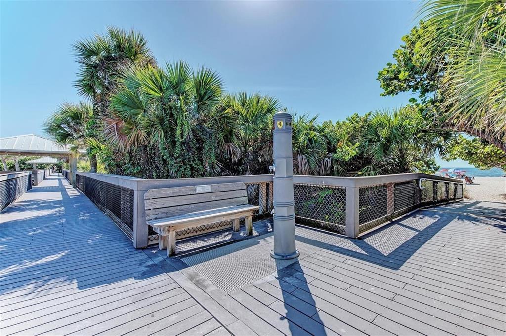 227 Lychee Road Nokomis, FL 34275 - Photo 29 of 36 a view of a wooden deck with a bench