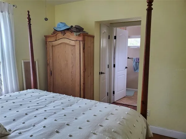 a bedroom with a bed and a mirror