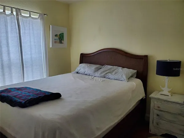 a bedroom with a bed and a mirror