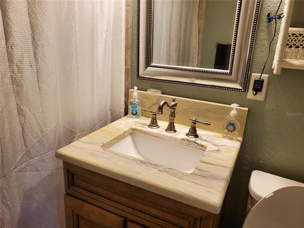 227 Lychee Road Nokomis, FL 34275 - Photo 10 of 36 a bathroom with a sink and a mirror