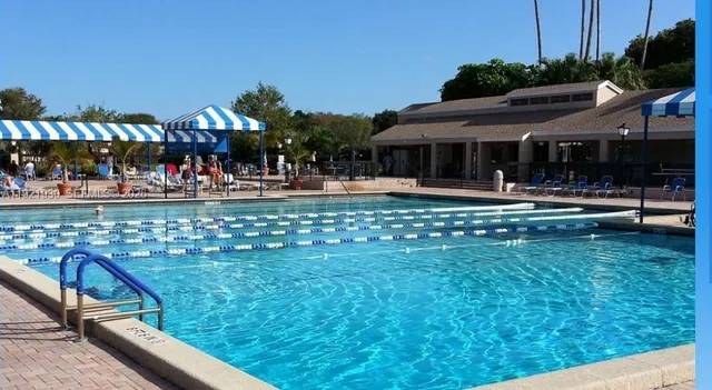 a view of a swimming pool with a yard