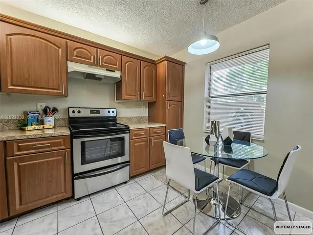 a kitchen with a stove a sink and cabinets