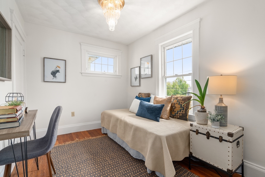 93 Puritan Road, Unit 93 Somerville, MA 02145 - Photo 15 of 20 a bedroom with a bed and wooden floor