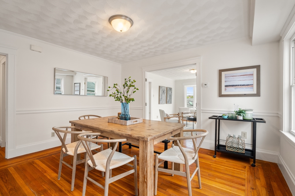 93 Puritan Road, Unit 93 Somerville, MA 02145 - Photo 6 of 20 a view of a dining room with furniture and wooden floor