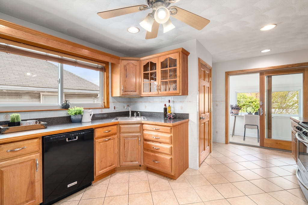 93 Puritan Road, Unit 93 Somerville, MA 02145 - Photo 9 of 20 a kitchen with a sink stove and cabinets