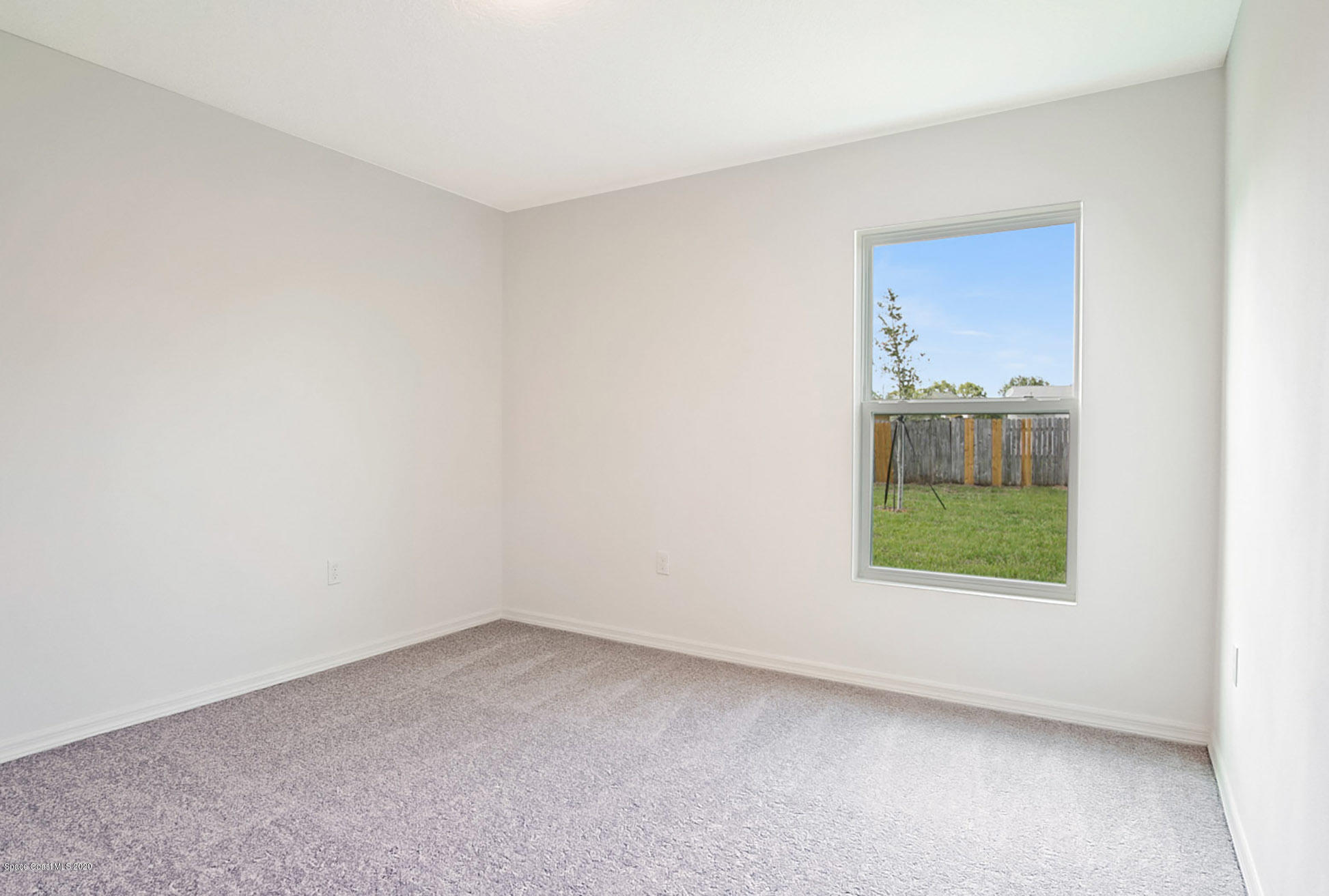 499 Scenic Road Palm Bay, FL 32908 - Photo 18 of 22 an empty room with a window