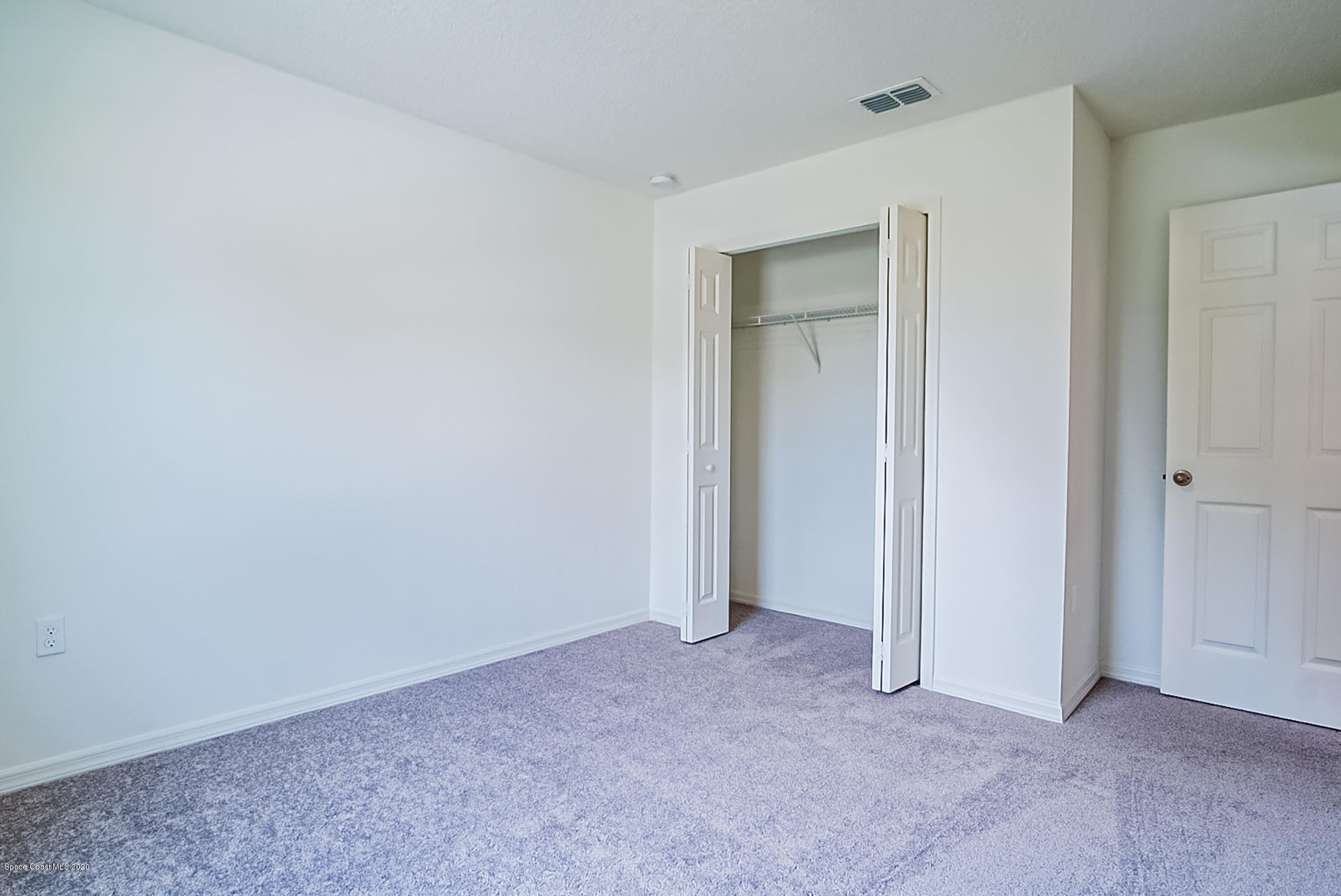 499 Scenic Road Palm Bay, FL 32908 - Photo 19 of 22 a view of an empty room and closet area