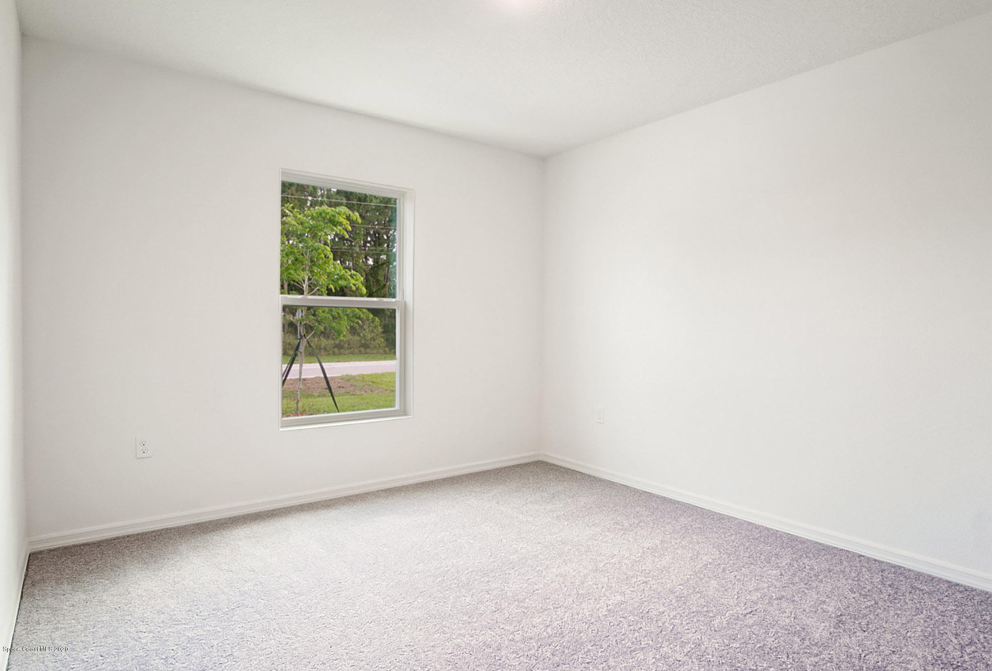 499 Scenic Road Palm Bay, FL 32908 - Photo 20 of 22 an empty room with a window