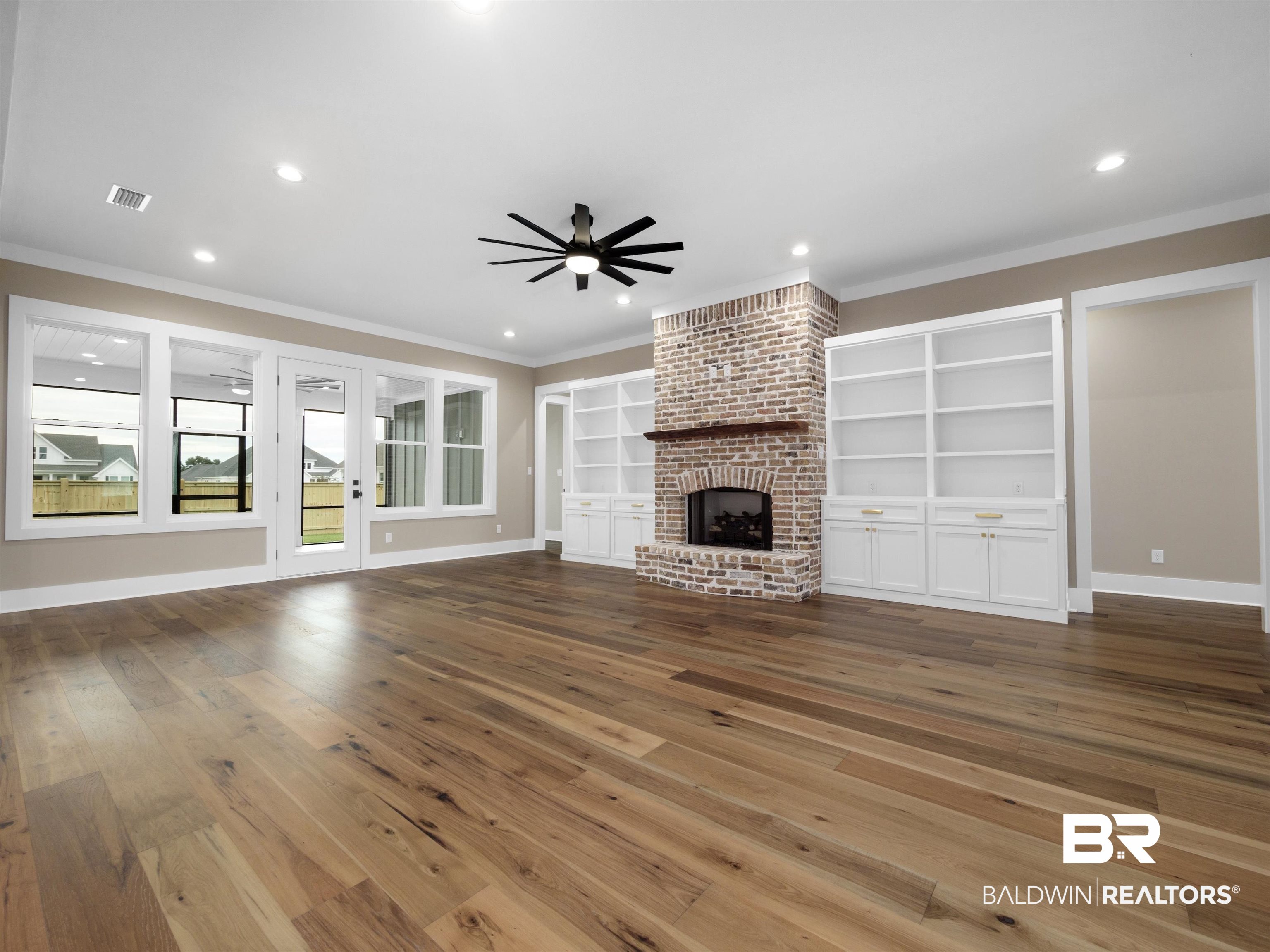 10970 Turin Avenue Fairhope, AL 36532 - Photo 4 of 61 Hardwood flooring, brick gas log/gas starter fireplace, ceiling fan, custom molding, built in cabinets, recessed lighting