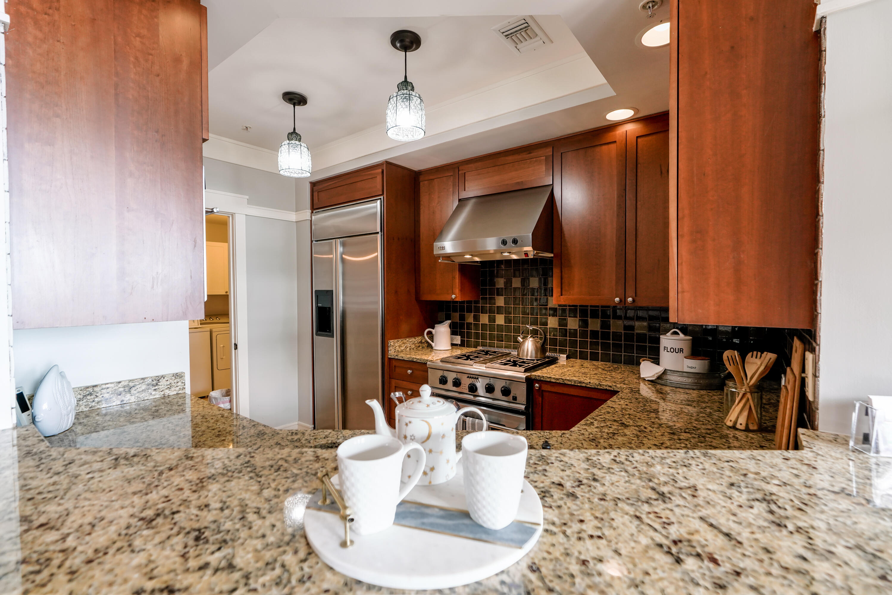 1101 Prospect Promenade, Unit 101 Panama City Beach, FL 32413 - Photo 11 of 49 a kitchen with a stove a sink and a refrigerator
