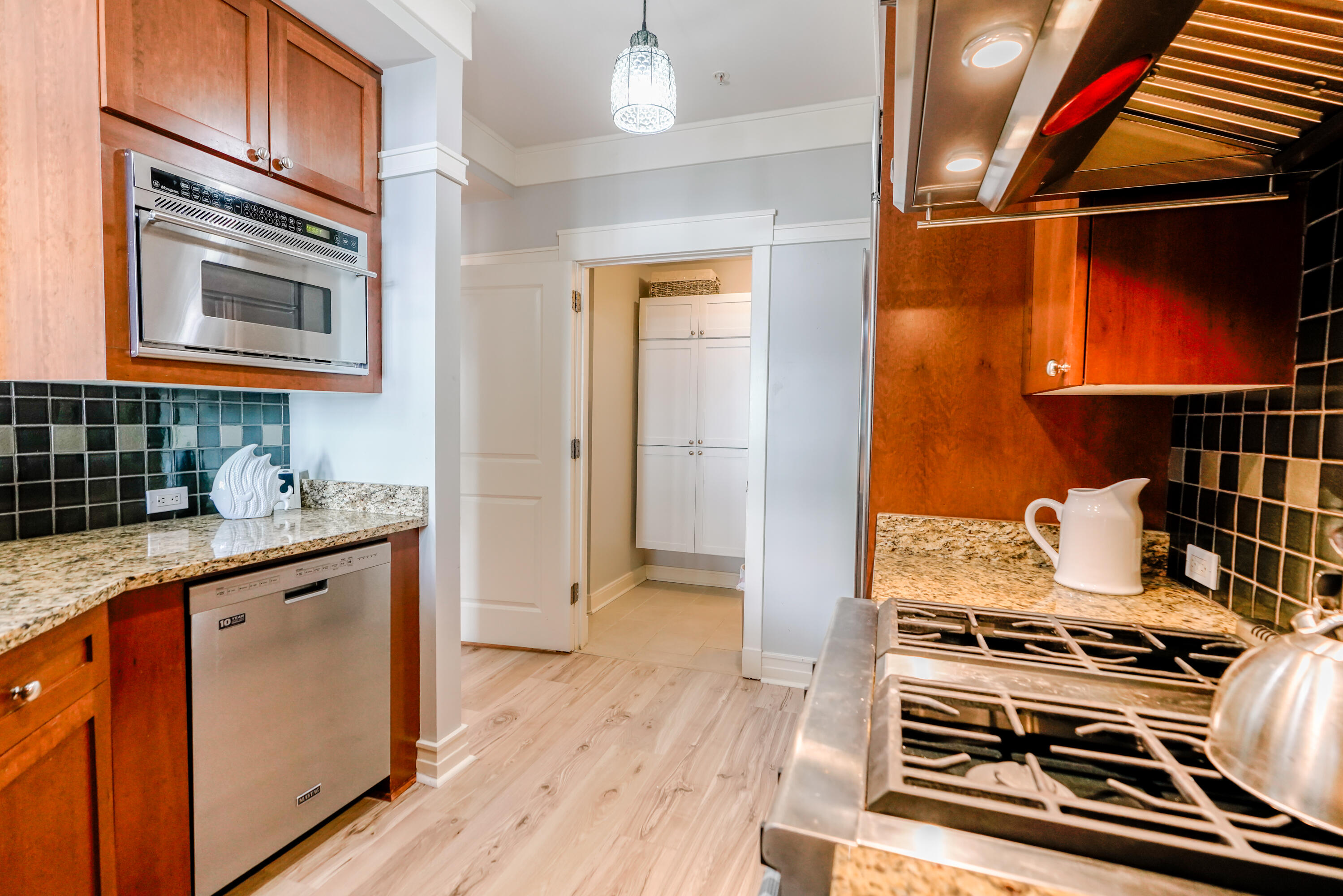 1101 Prospect Promenade, Unit 101 Panama City Beach, FL 32413 - Photo 12 of 49 a kitchen with stainless steel appliances granite countertop a stove and a sink