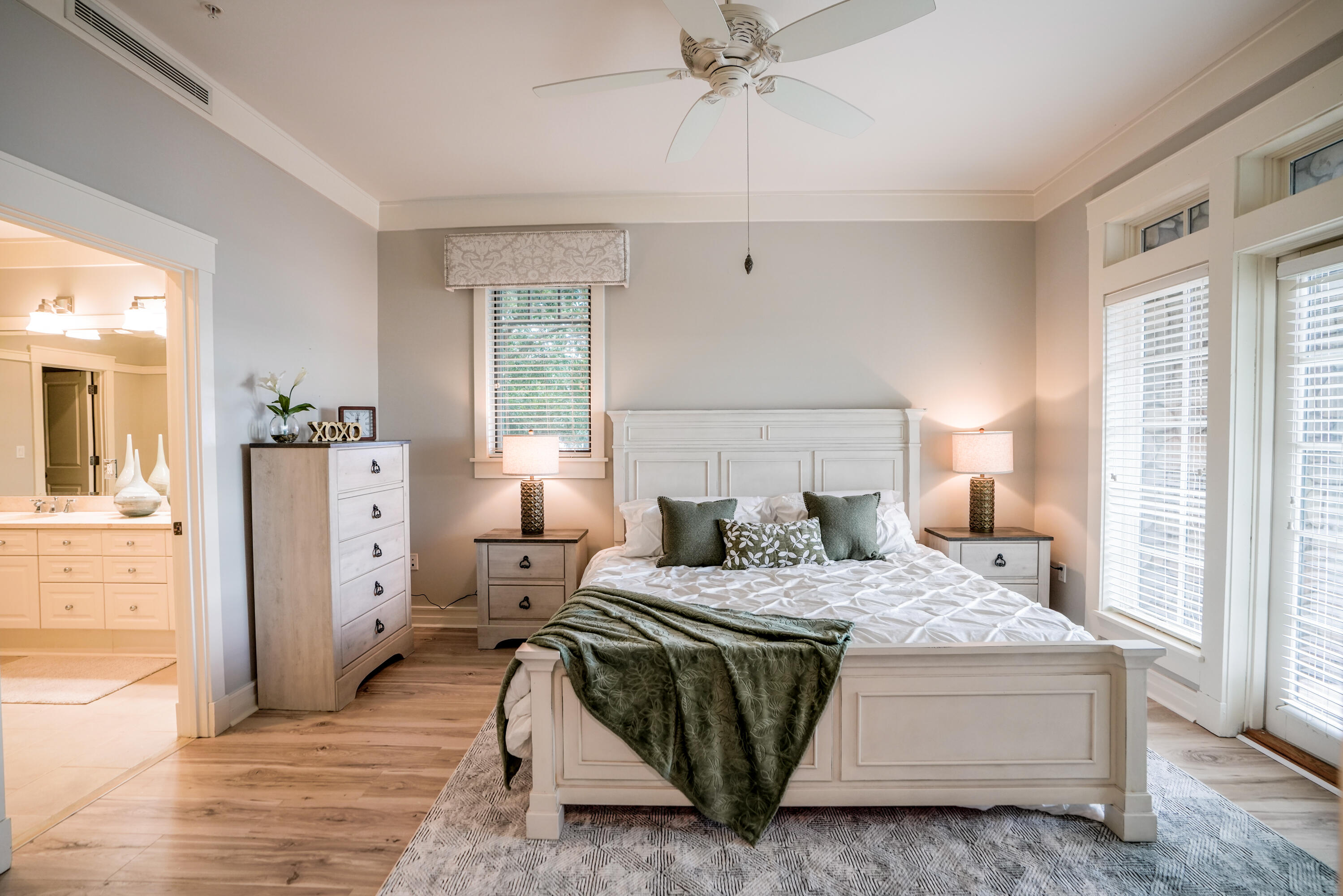1101 Prospect Promenade, Unit 101 Panama City Beach, FL 32413 - Photo 14 of 49 a bedroom with a bed and wooden floor