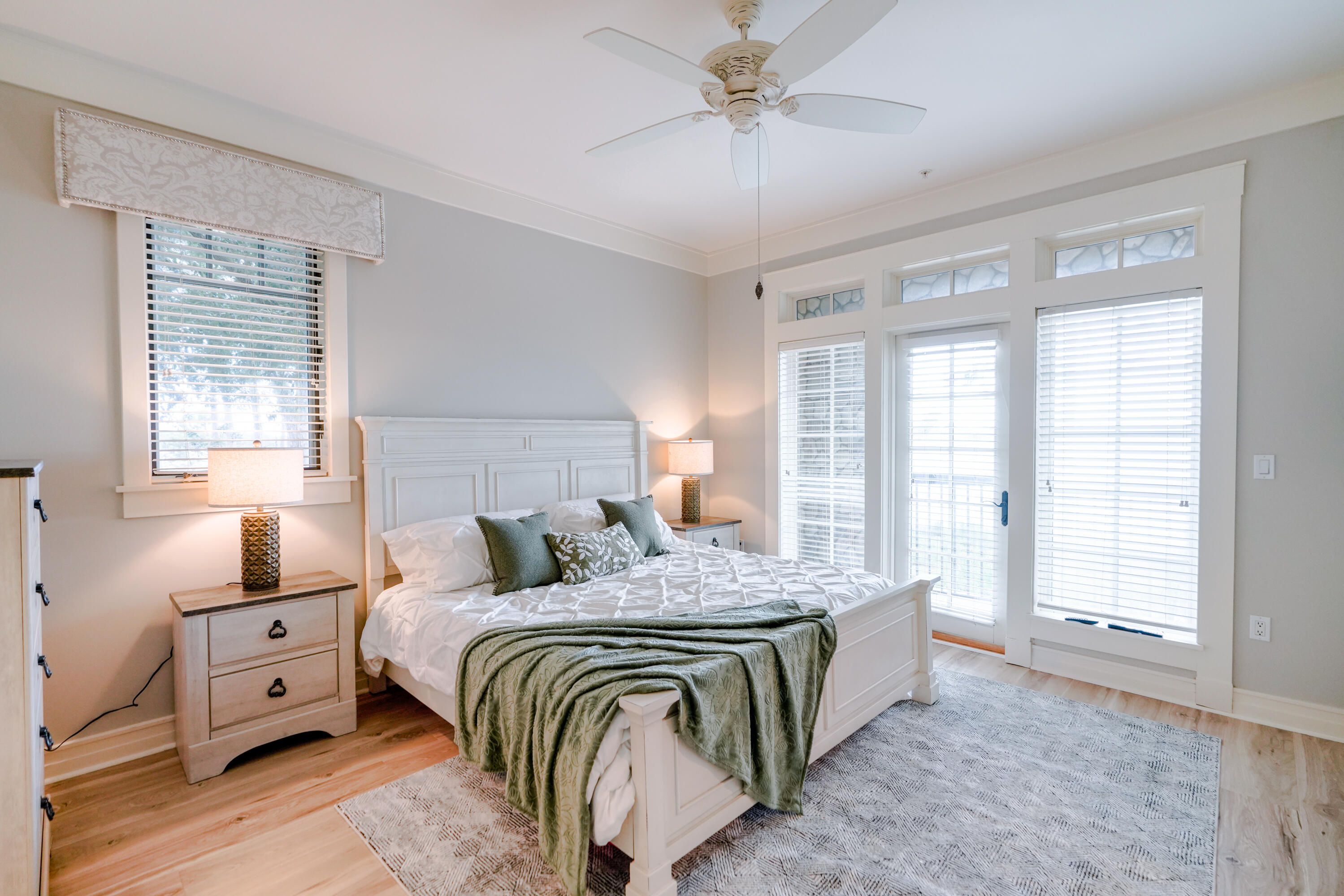 1101 Prospect Promenade, Unit 101 Panama City Beach, FL 32413 - Photo 15 of 49 a bedroom with a bed and wooden floor