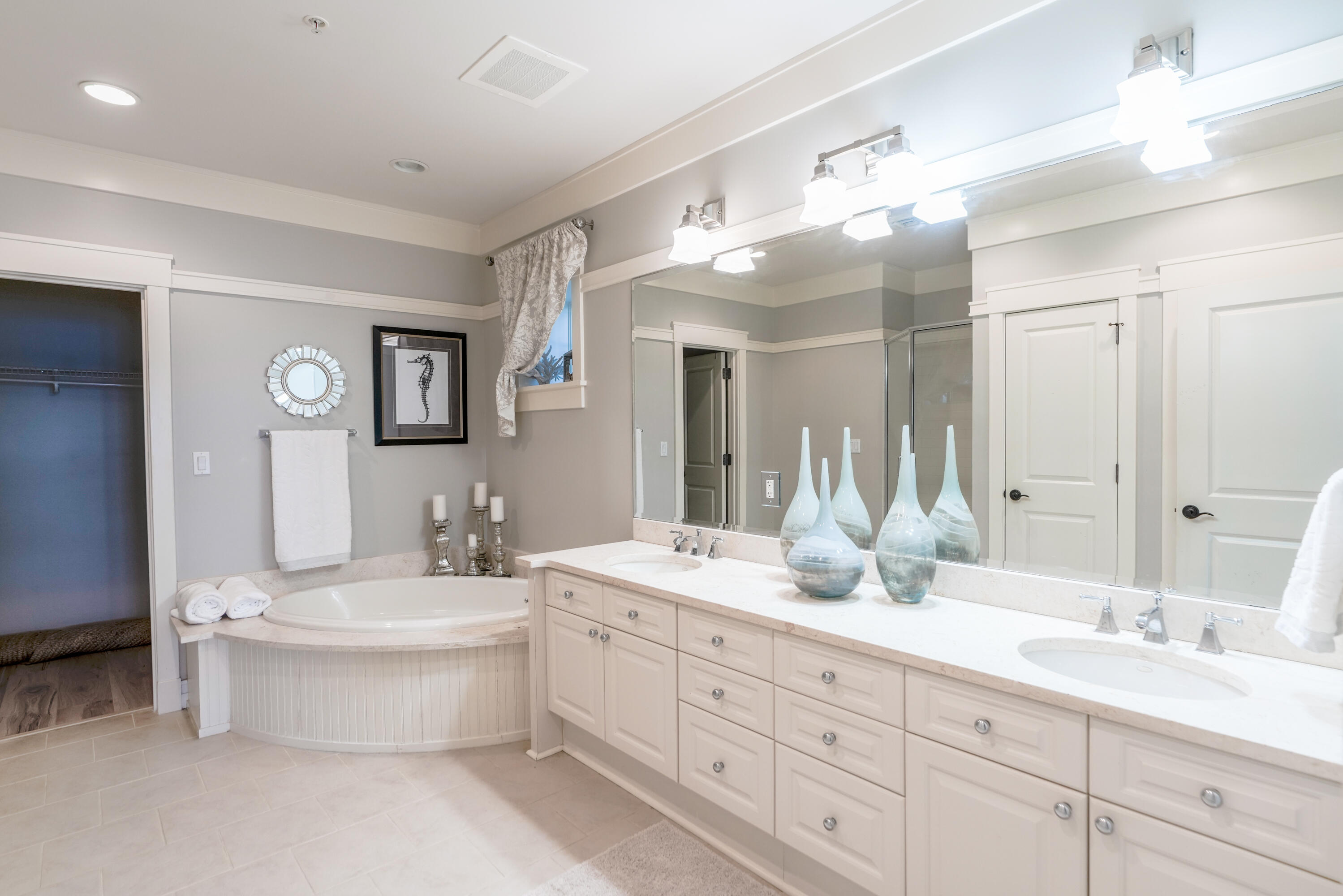 1101 Prospect Promenade, Unit 101 Panama City Beach, FL 32413 - Photo 16 of 49 a bathroom with a double vanity sink mirror and bathtub