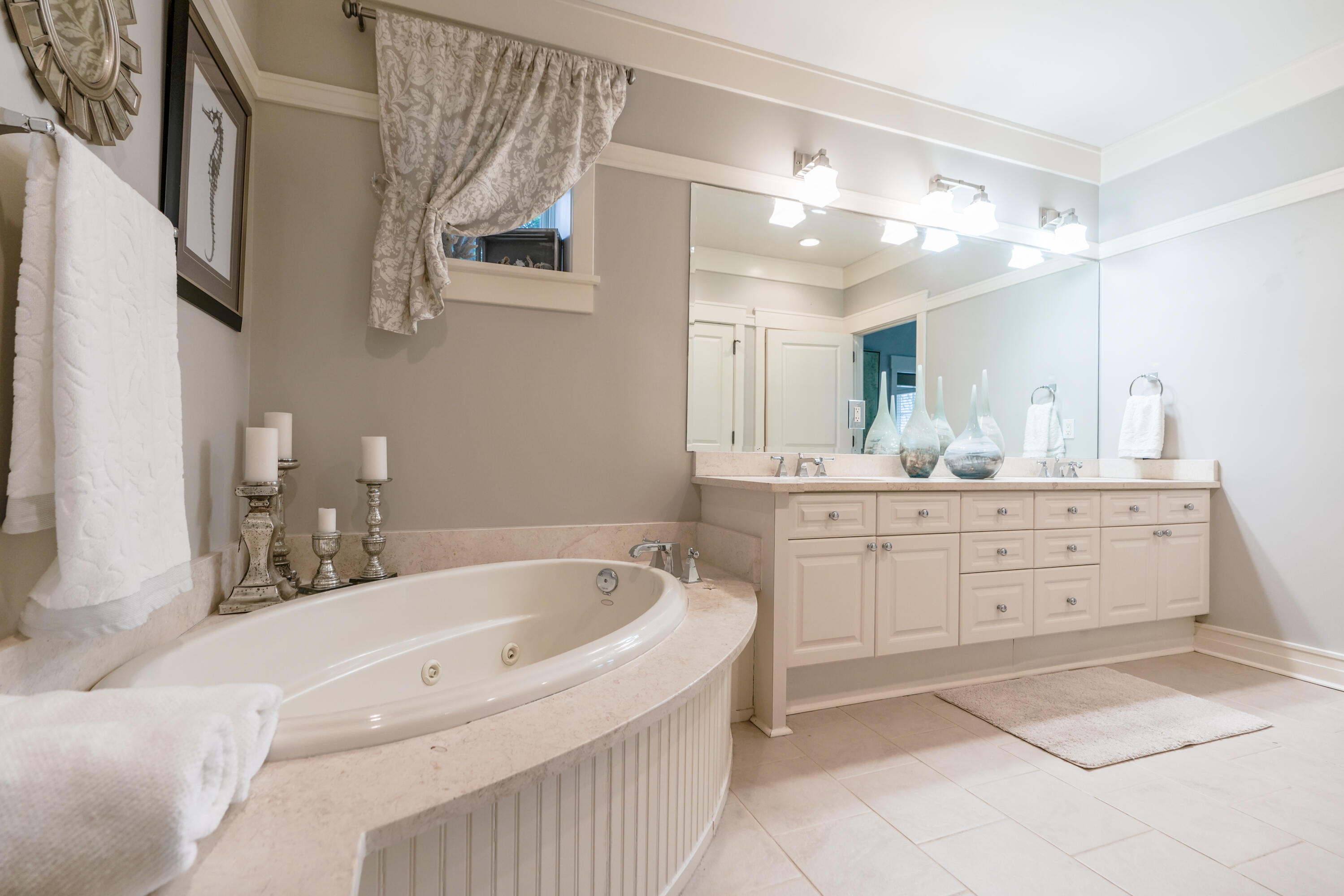 1101 Prospect Promenade, Unit 101 Panama City Beach, FL 32413 - Photo 17 of 49 a bathroom with a bathtub sink and a mirror