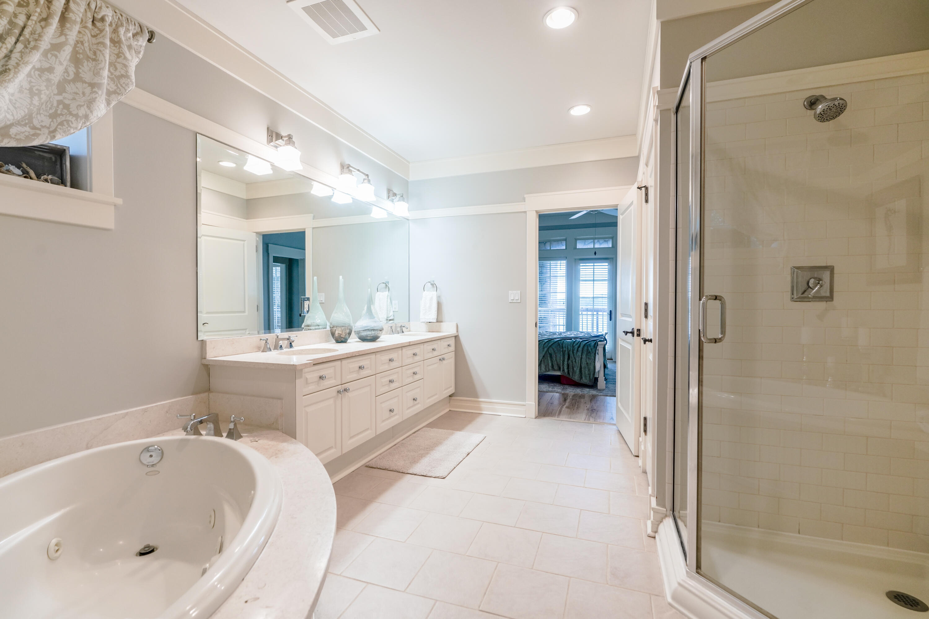 1101 Prospect Promenade, Unit 101 Panama City Beach, FL 32413 - Photo 18 of 49 a bathroom with a bathtub shower and a sink