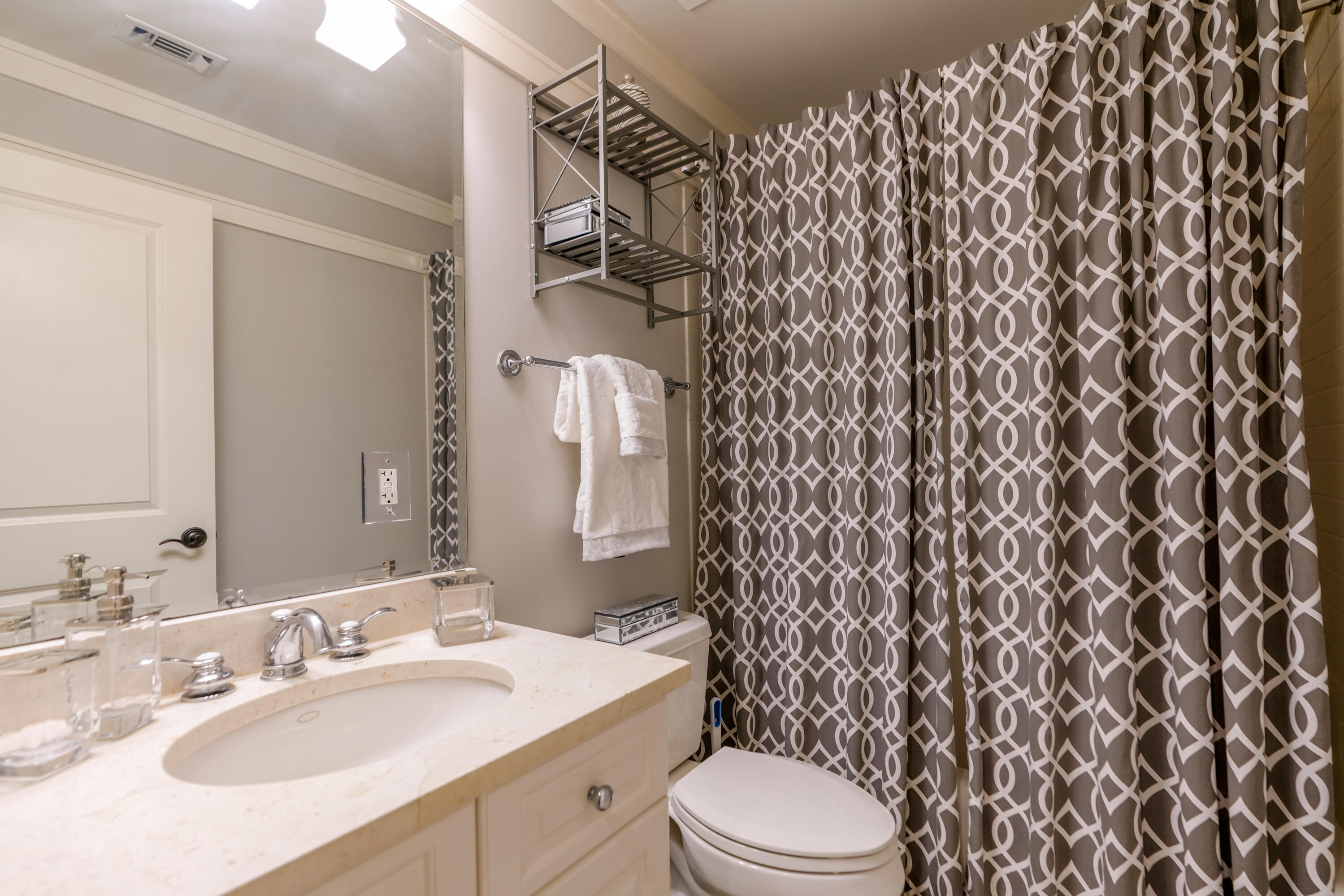 1101 Prospect Promenade, Unit 101 Panama City Beach, FL 32413 - Photo 20 of 49 a bathroom with a sink toilet and shower