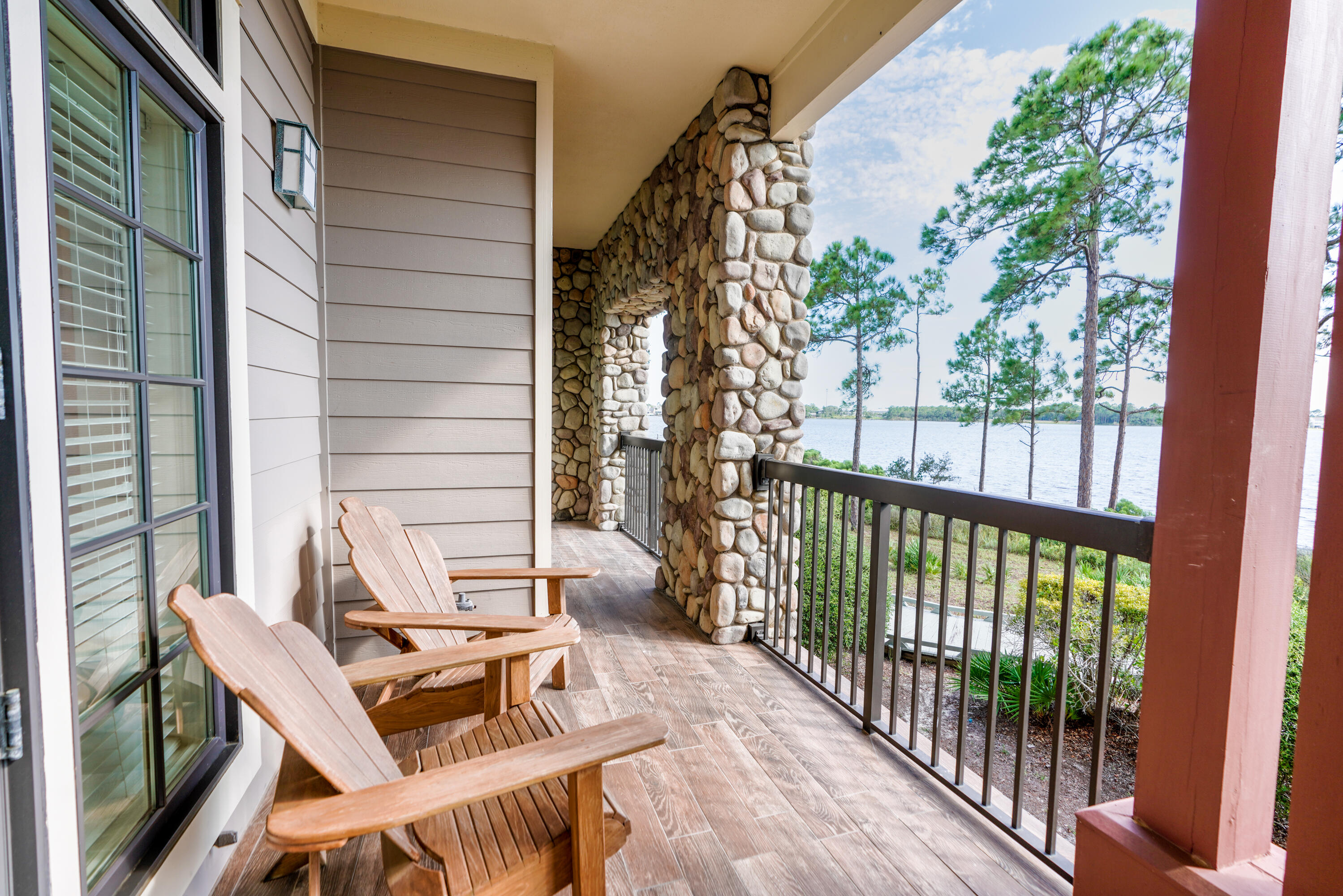 1101 Prospect Promenade, Unit 101 Panama City Beach, FL 32413 - Photo 25 of 49 a view of balcony with wooden floor and outdoor seating