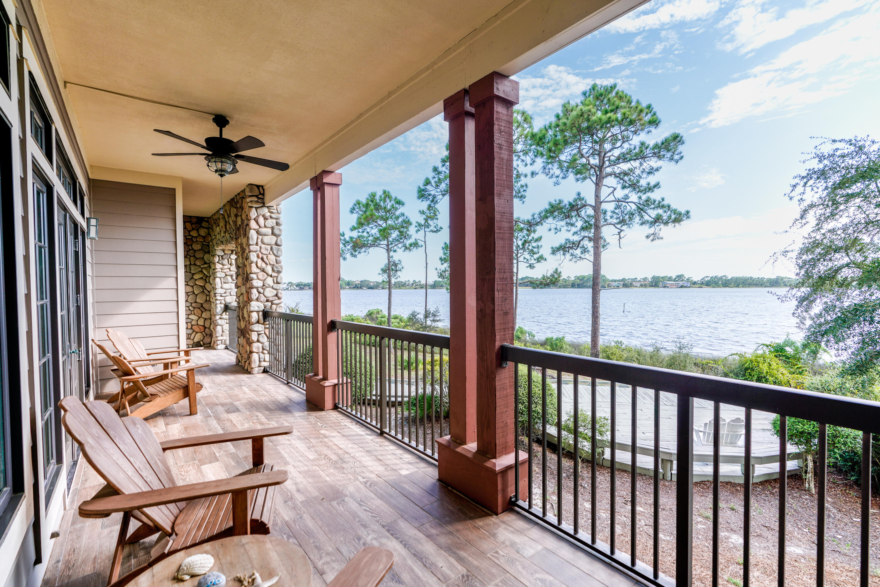 1101 Prospect Promenade, Unit 101 Panama City Beach, FL 32413 - Photo 27 of 49 a view of a balcony with furniture and wooden floor