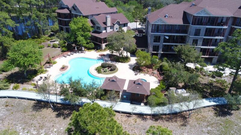 1101 Prospect Promenade, Unit 101 Panama City Beach, FL 32413 - Photo 30 of 49 a view of a garden with plants and a fountain