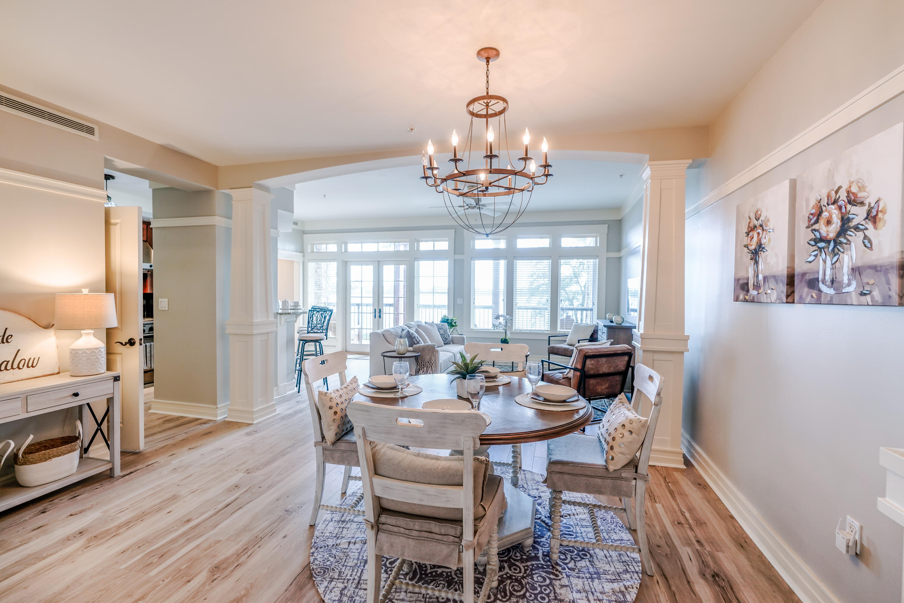 1101 Prospect Promenade, Unit 101 Panama City Beach, FL 32413 - Photo 4 of 49 a view of a dining room with furniture window and wooden floor