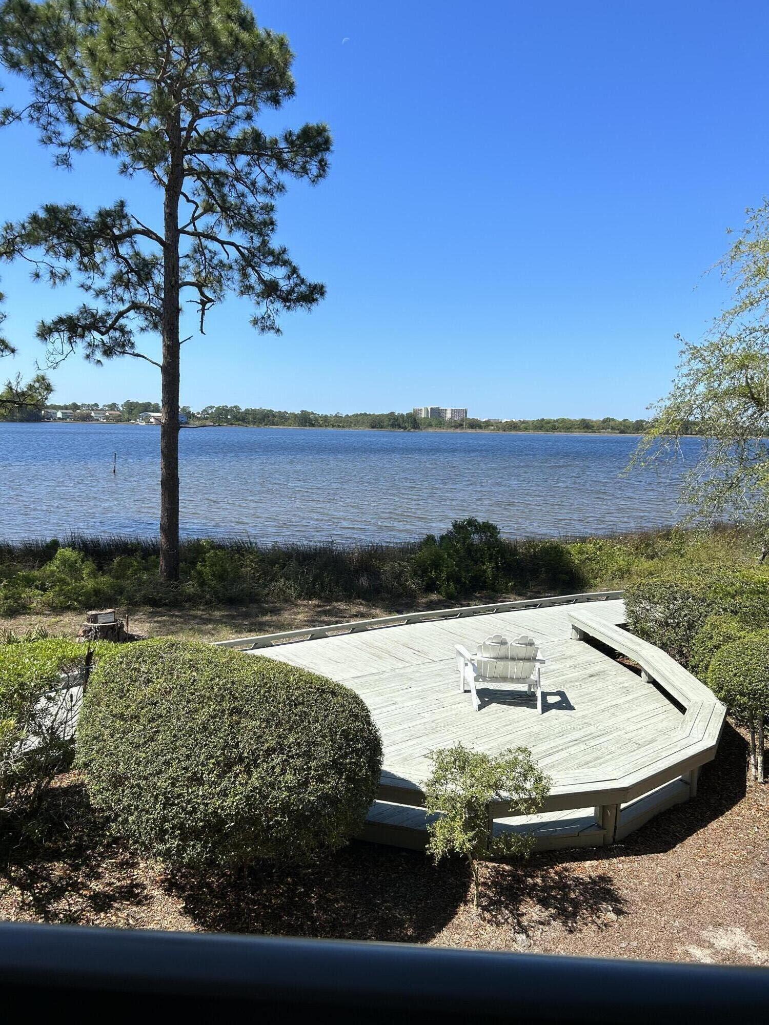 1101 Prospect Promenade, Unit 101 Panama City Beach, FL 32413 - Photo 41 of 49 a view of a swimming pool with a yard
