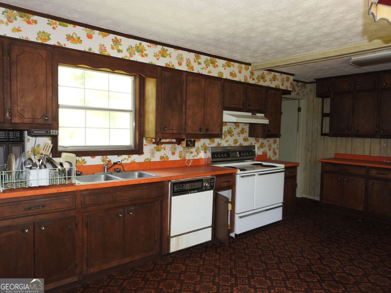 333 Lickskillet Road Epworth, GA 30541 - Photo 13 of 38 a kitchen with a sink stove and cabinets